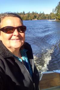 Lynn Knight in a boat on Saranac Lake