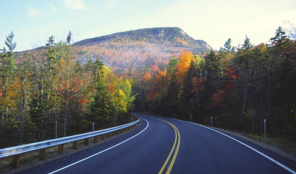 Autumn road to mountains by UNH